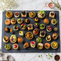 Mozaic assorted canapes with elegant bite-sized presentation for premium catering