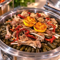 Mozaic stuffed vine leaves with tender lamb and grilled lemon for premium catering