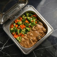 Mozaic chicken main course with creamy brown sauce and mixed vegetables